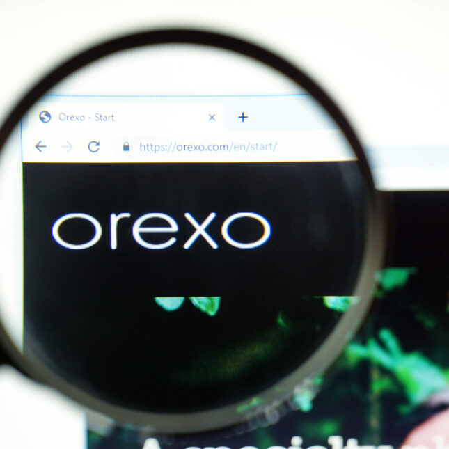 Through a magnifier, a laptop displays a webpage and logo of Orexo -- coverage from STAT