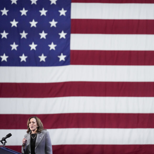 Vice President Kamala Harris speaks at a campaign event with an American flag in the background. -- health policy coverage from STAT