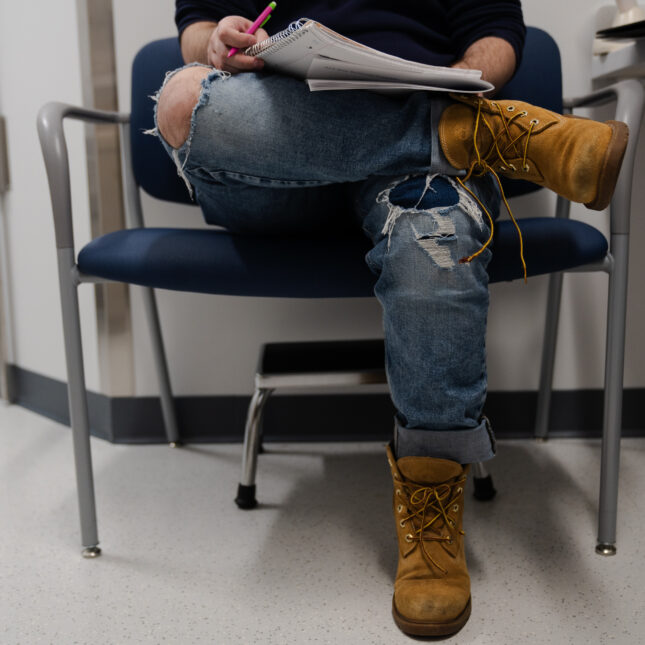 A patient takes notes during a pre-op consultation about receiving a phalloplasty. -- health coverage from STAT