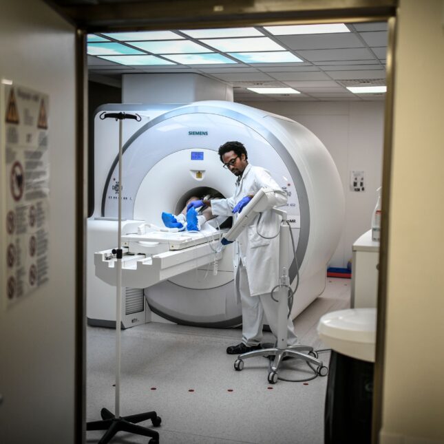 A radiologist supervises a patient undergoing a MRI -- health tech coverage from STAT