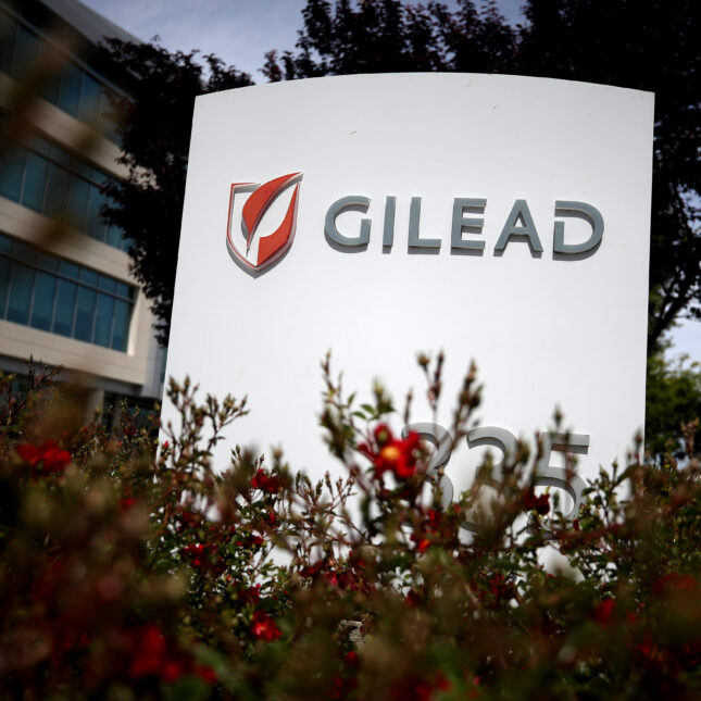 A sign of Gilead Sciences stands next to its headquarter, surrounded by shrubs — biotech coverage from STAT