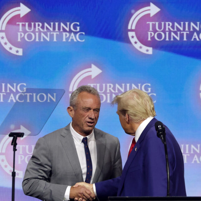 Republican presidential nominee, former U.S. President Donald Trump, shakes hands with Robert F. Kennedy Jr. during a campaign rally. --politics coverage from STAT